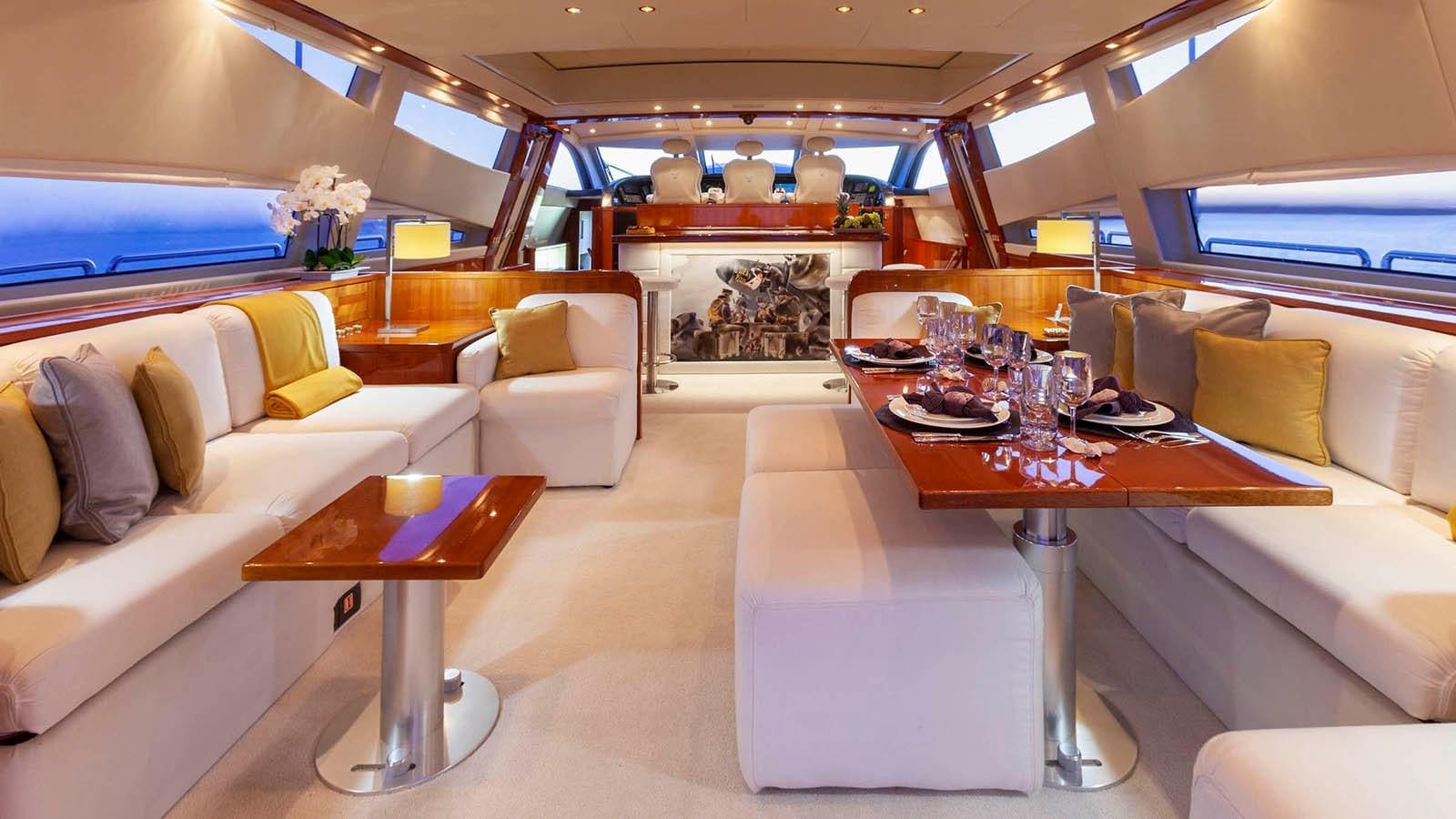 a room with a table and chairs aboard KIDI ONE Yacht for Sale