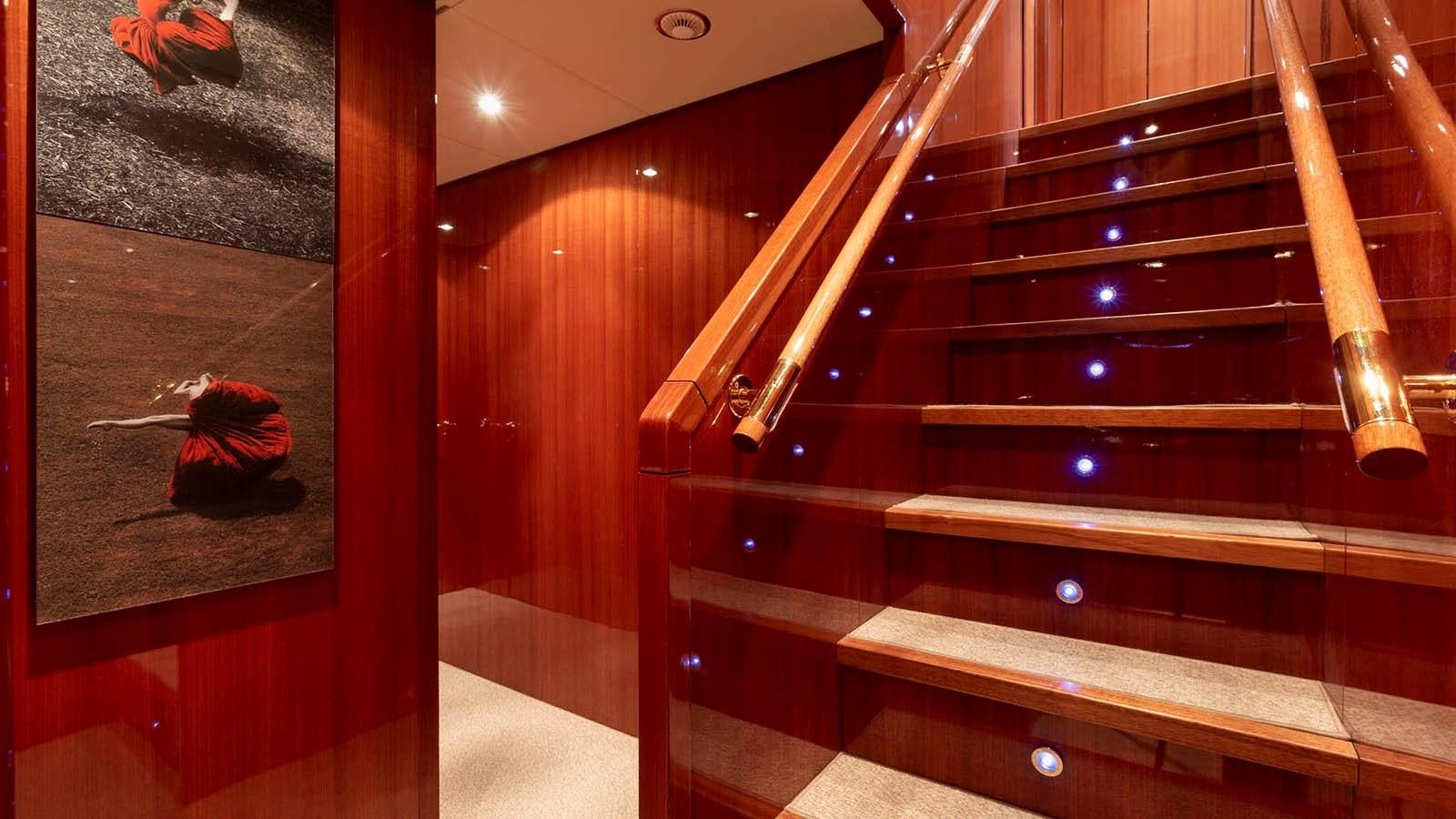 a wooden cabinet with a mirror and a person sitting on it aboard KIDI ONE Yacht for Sale