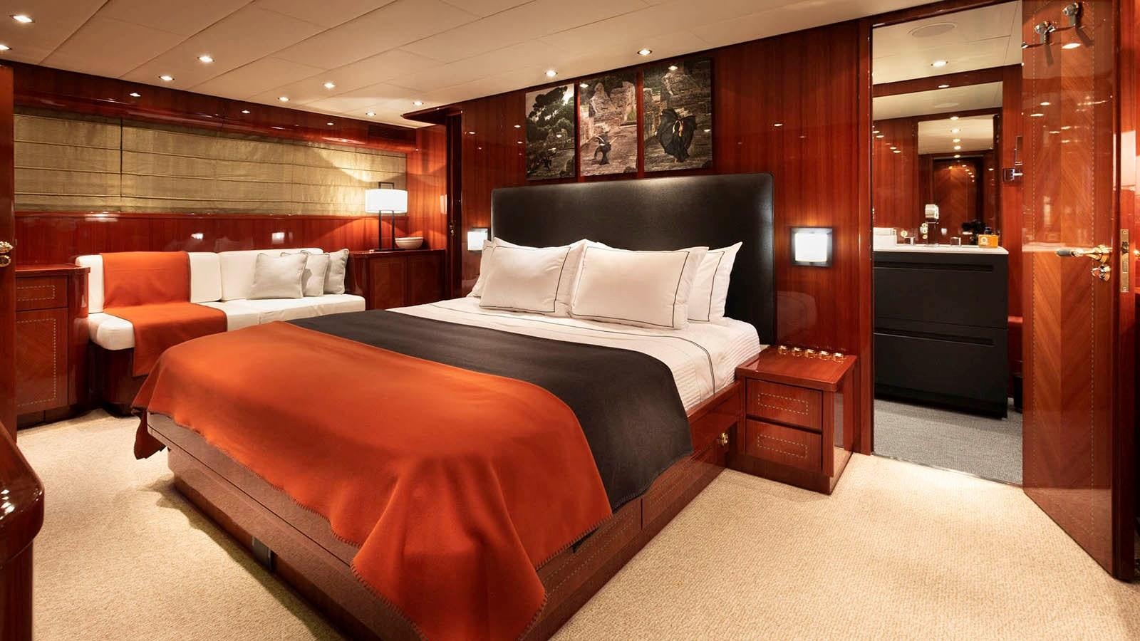 a room with a bed and a couch aboard KIDI ONE Yacht for Sale