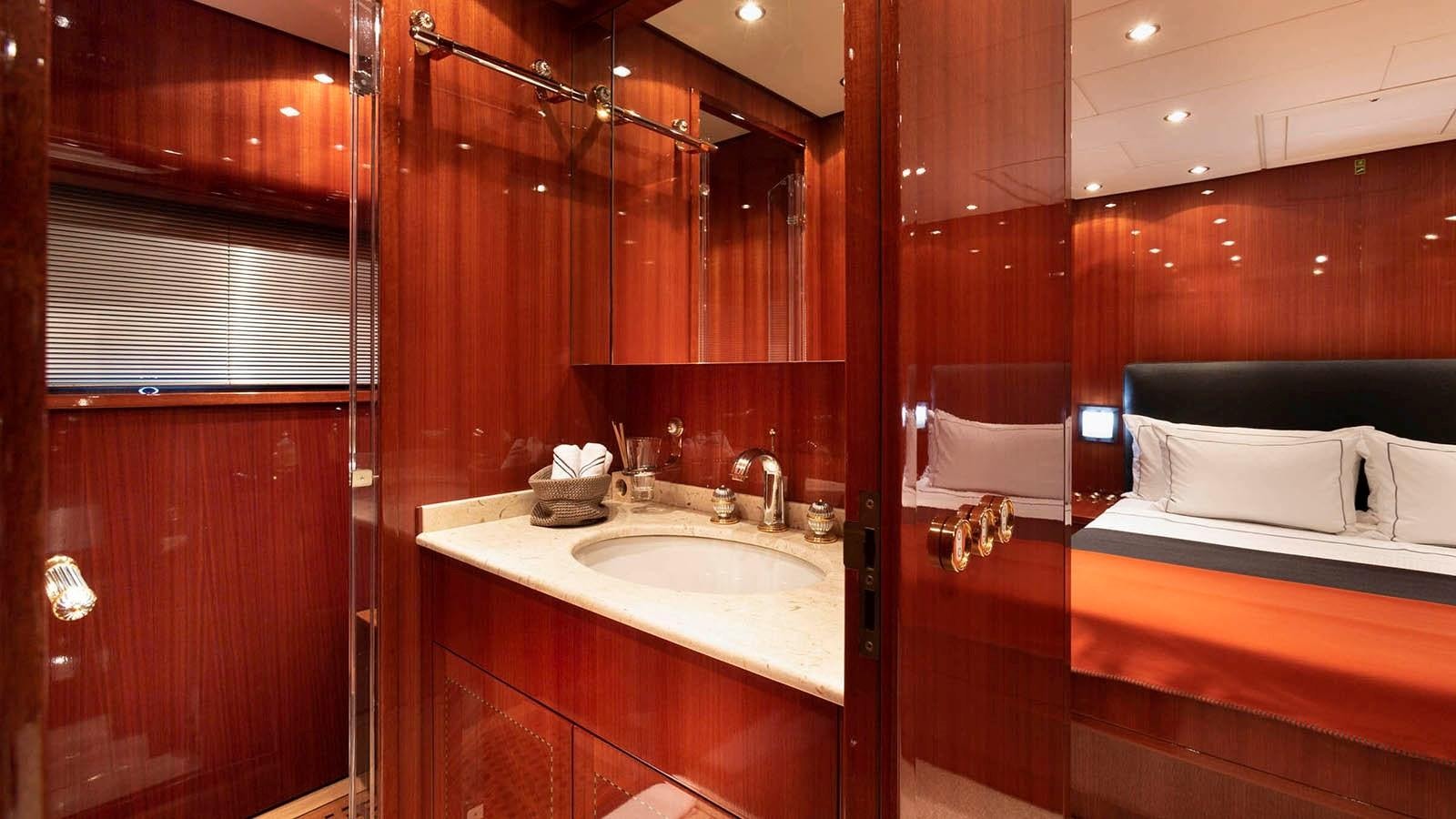 a bathroom with a sink and a bed aboard KIDI ONE Yacht for Sale