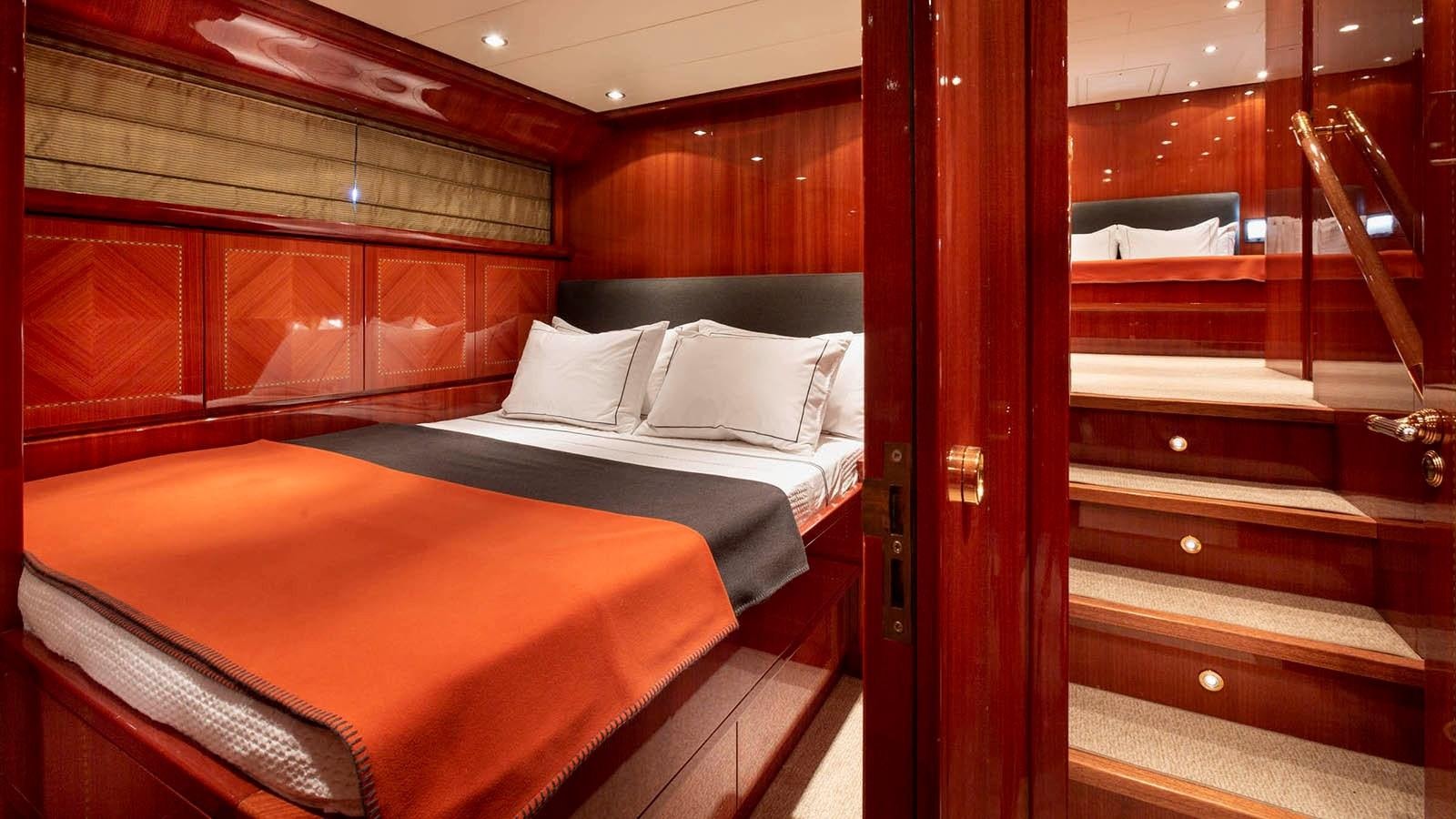 a room with a bed and a wood wall aboard KIDI ONE Yacht for Sale