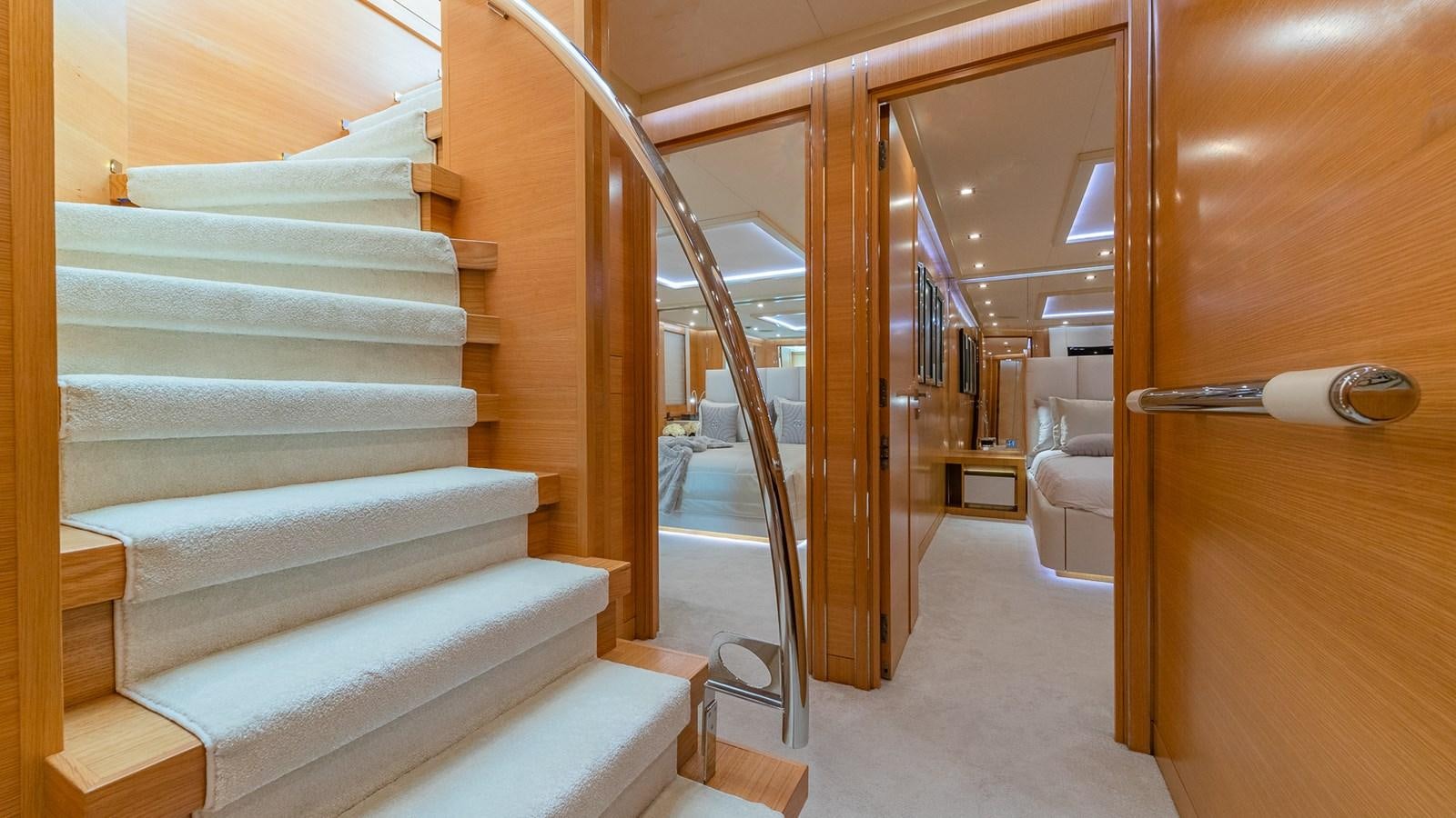 a wooden staircase in a house aboard DB9 Yacht for Charter