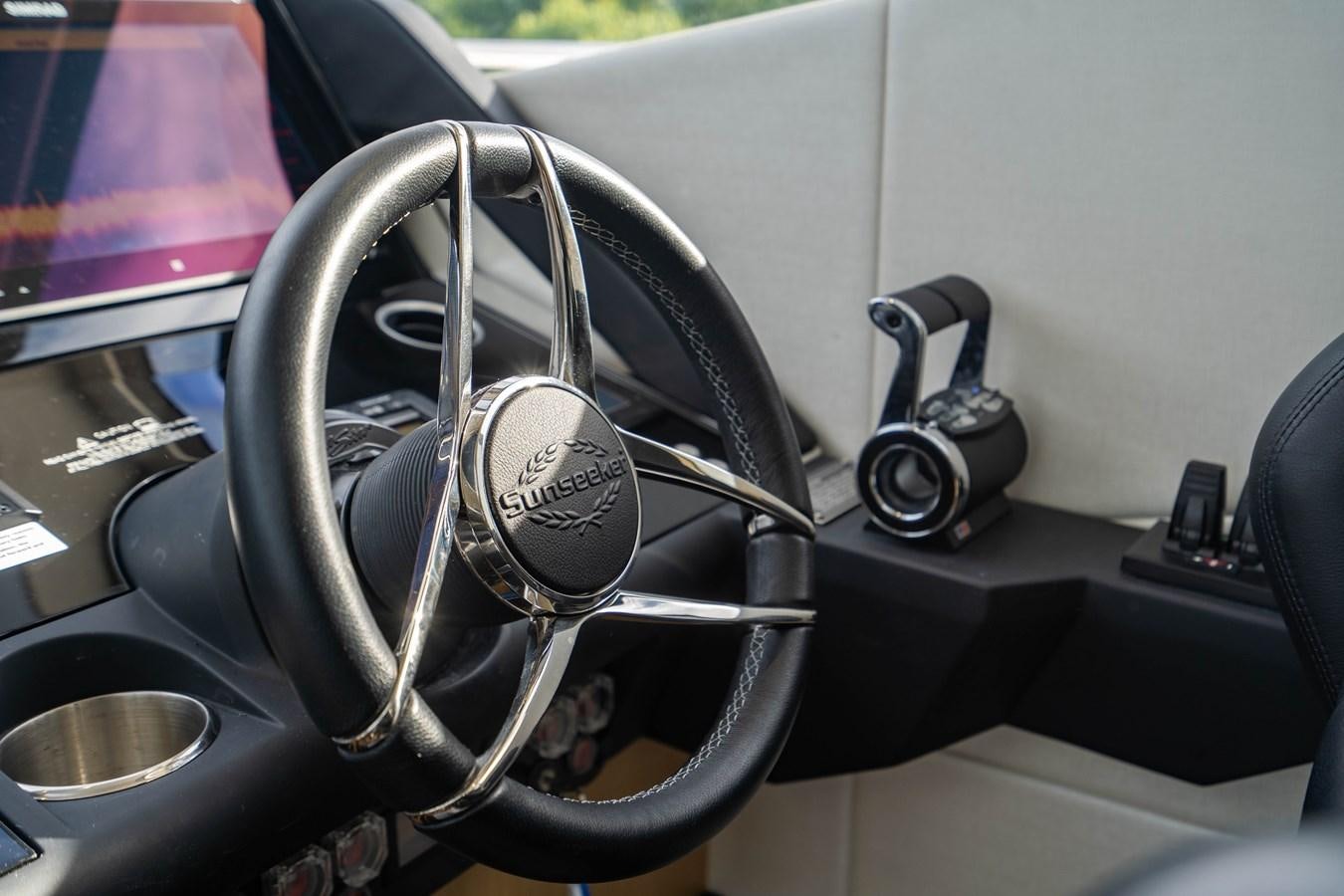 the steering wheel and dashboard of a car aboard SUBMARINO Yacht for Sale