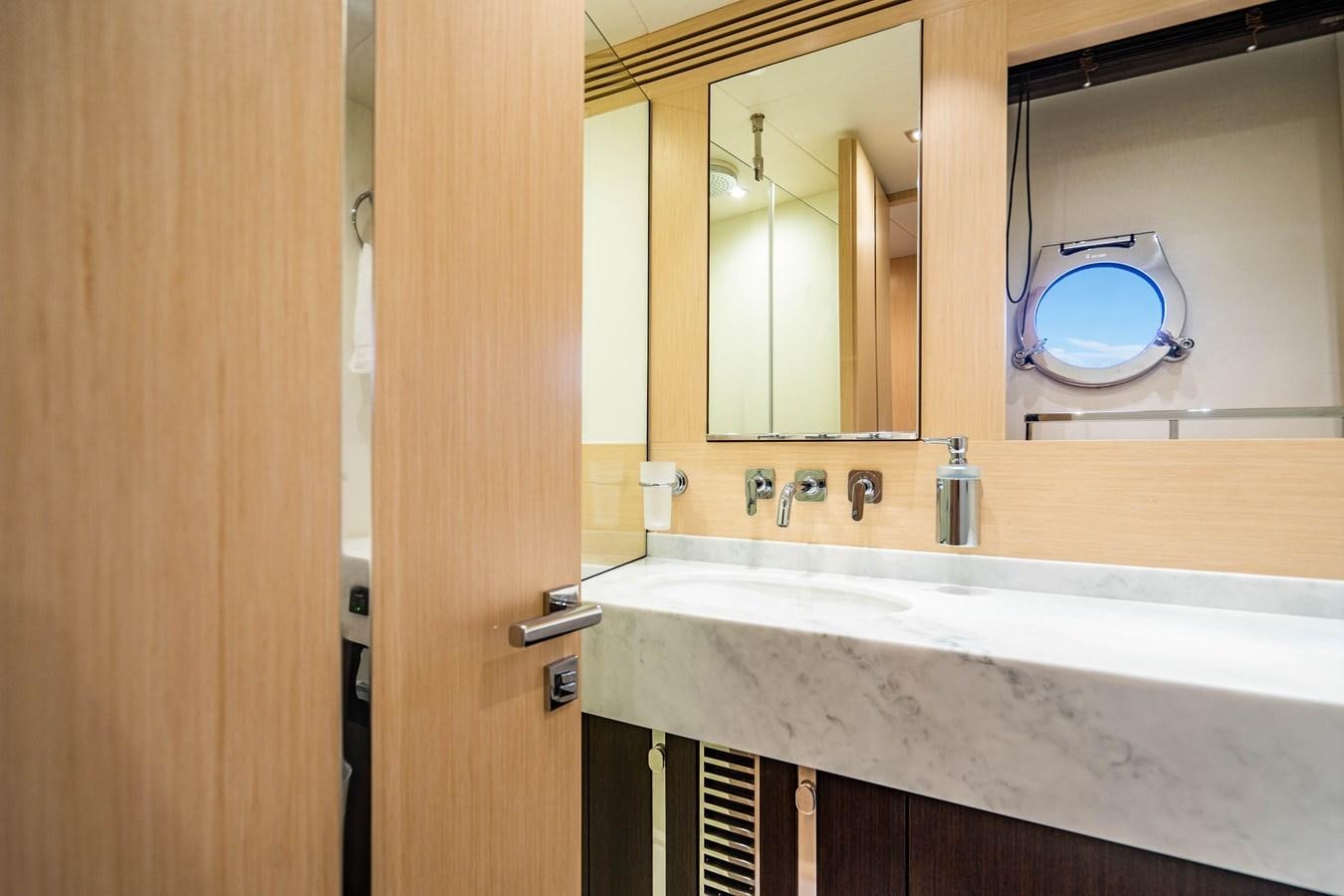 a bathroom with a round mirror aboard SUBMARINO Yacht for Sale
