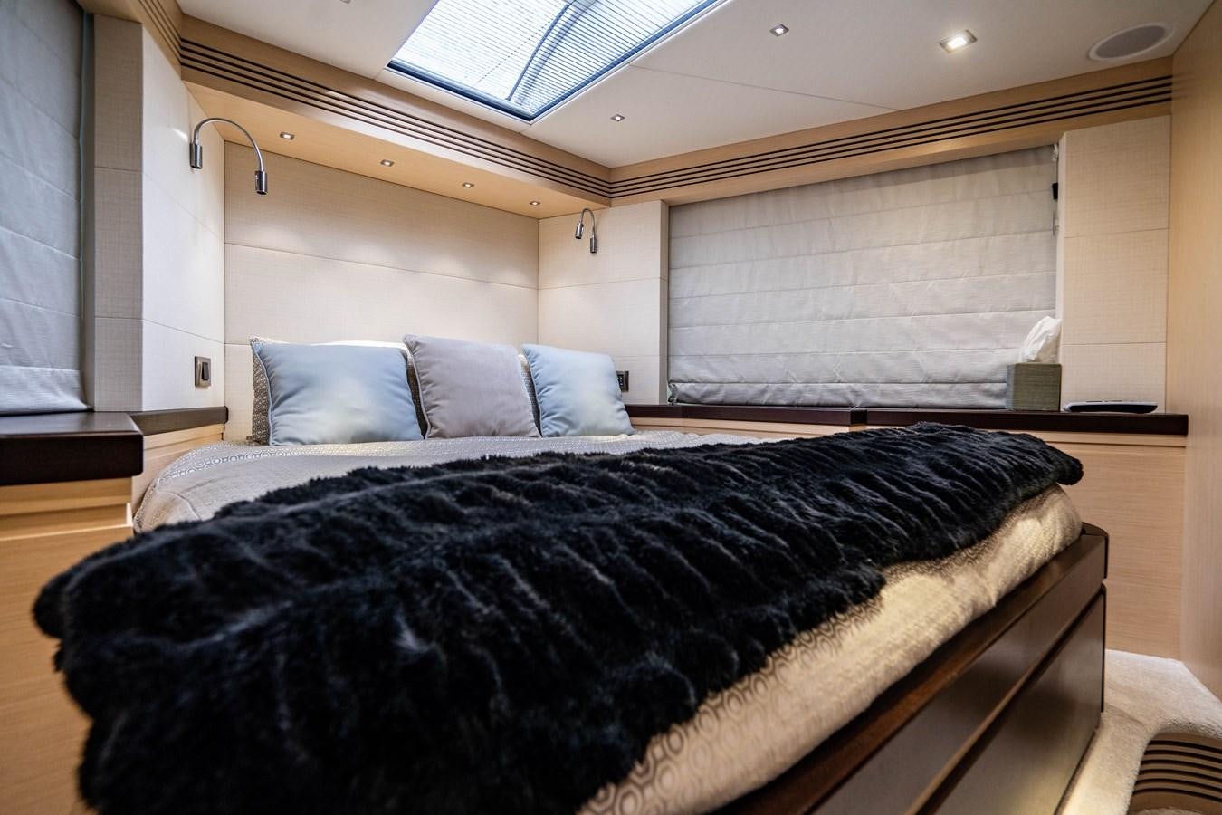 a bed with a black comforter aboard SUBMARINO Yacht for Sale