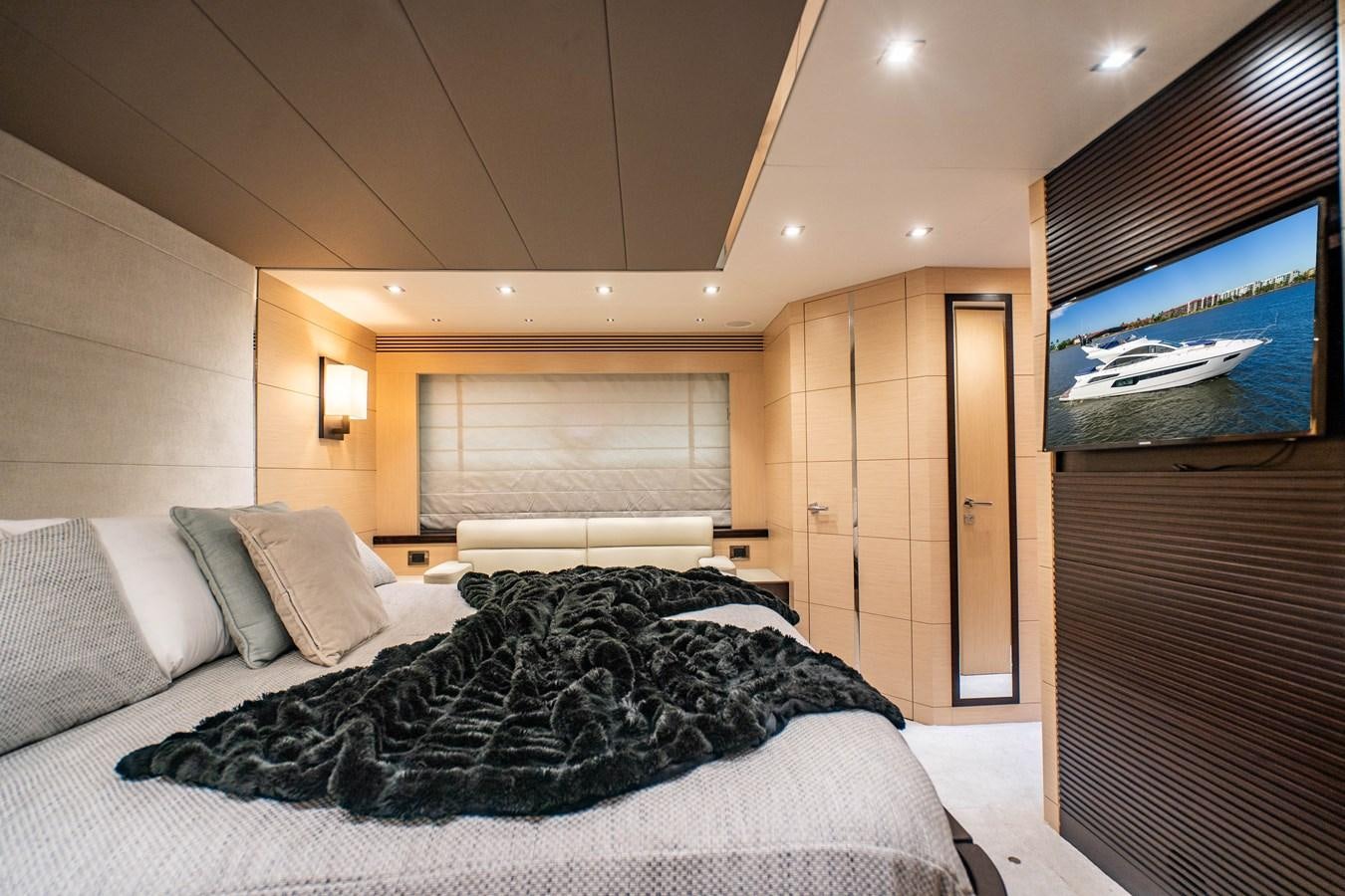 a bedroom with a bed and a tv aboard SUBMARINO Yacht for Sale