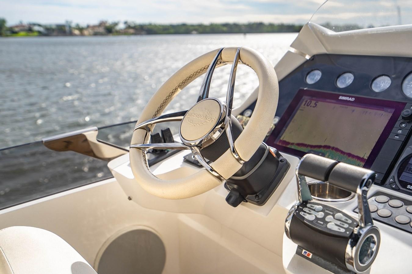 a steering wheel and dashboard of a boat aboard SUBMARINO Yacht for Sale