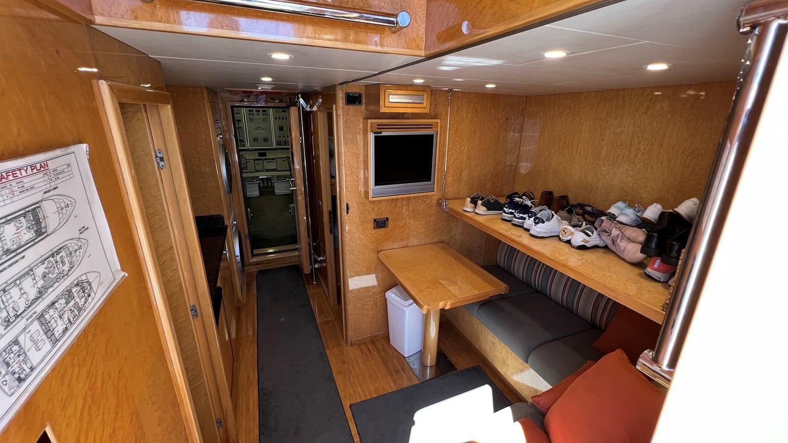a room with a tv and a table aboard MISSY B II Yacht for Sale