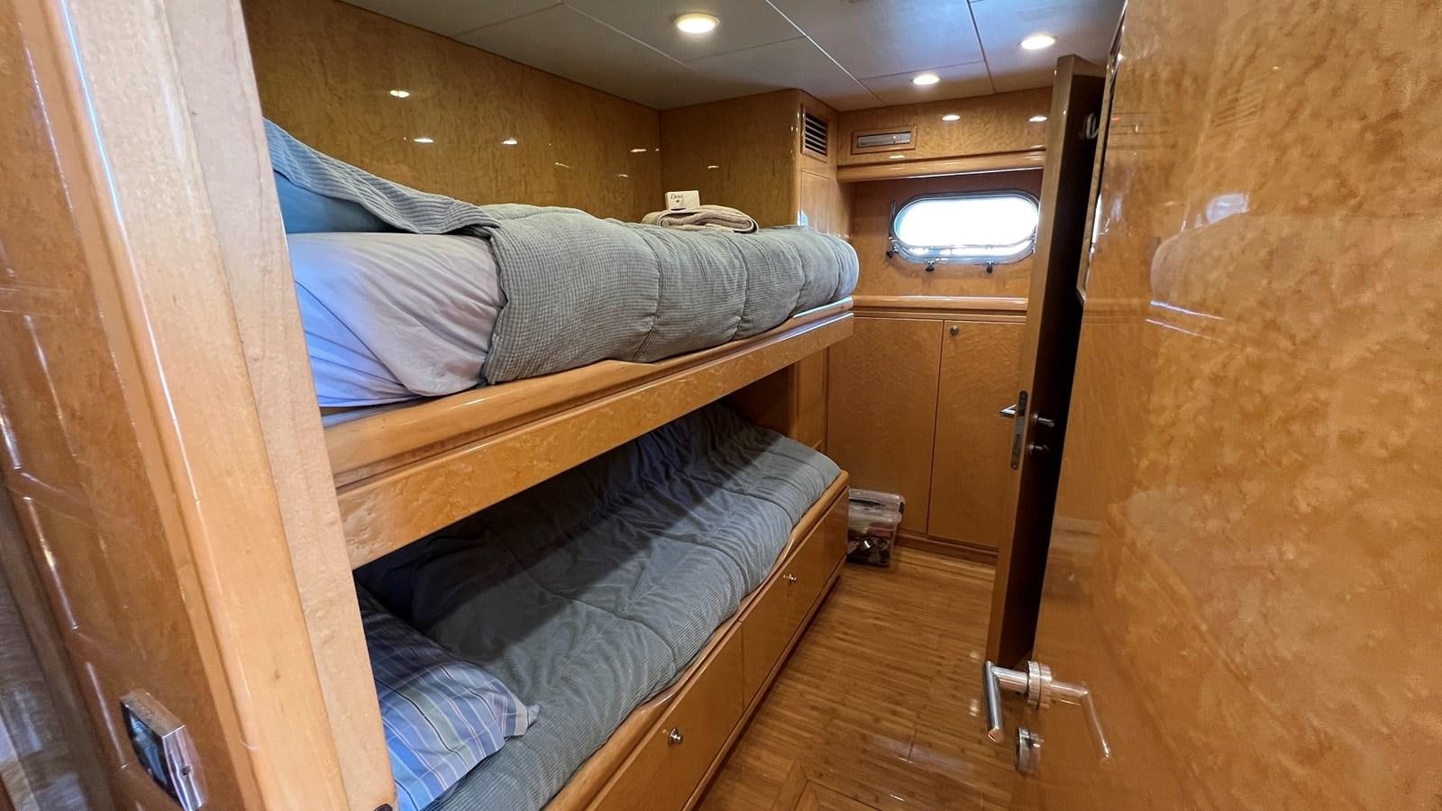 a room with a bed and a door aboard MISSY B II Yacht for Sale