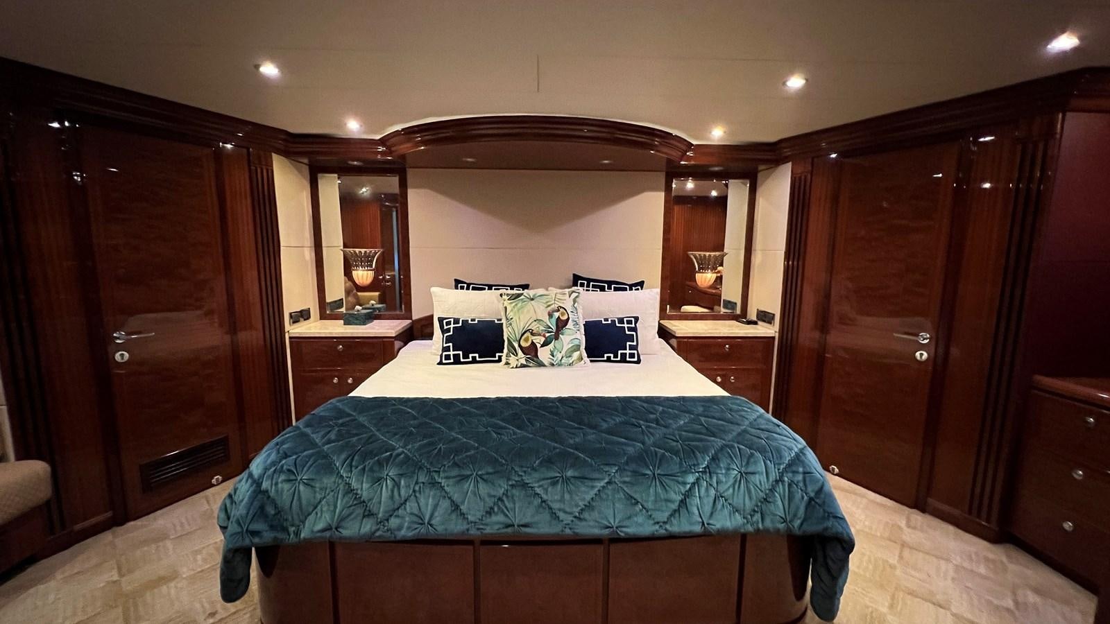 a bed with blue sheets aboard MISSY B II Yacht for Sale