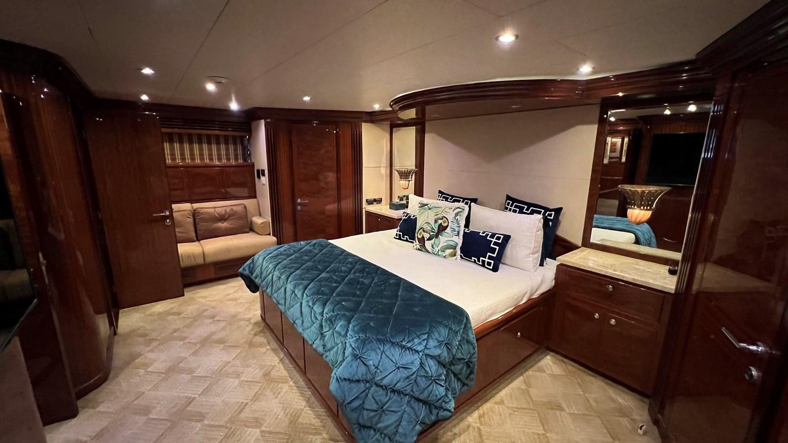 a bedroom with a bed and a wood door aboard MISSY B II Yacht for Sale