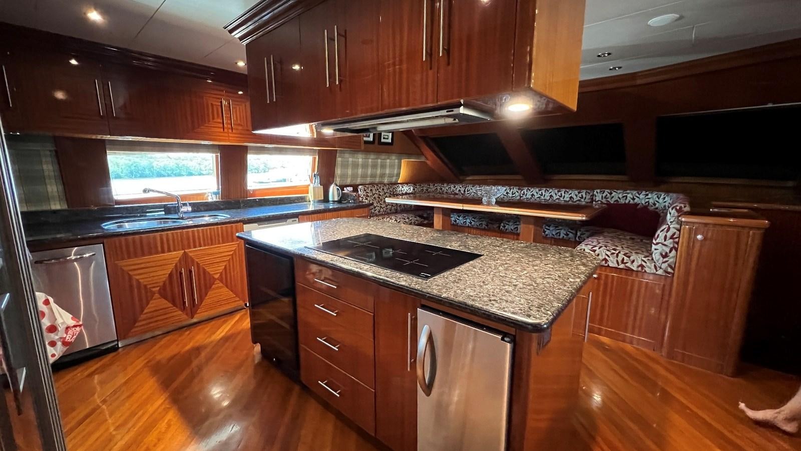a kitchen with a stove and a couch aboard MISSY B II Yacht for Sale