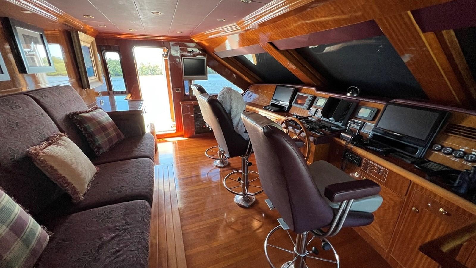 a living room with a couch and a television aboard MISSY B II Yacht for Sale