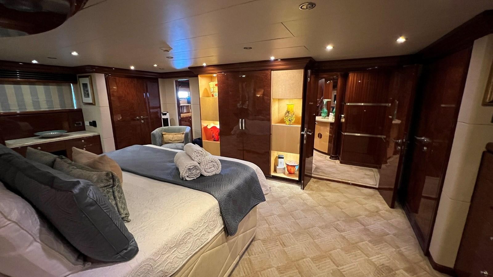 a bedroom with a bed and a wood door aboard MISSY B II Yacht for Sale