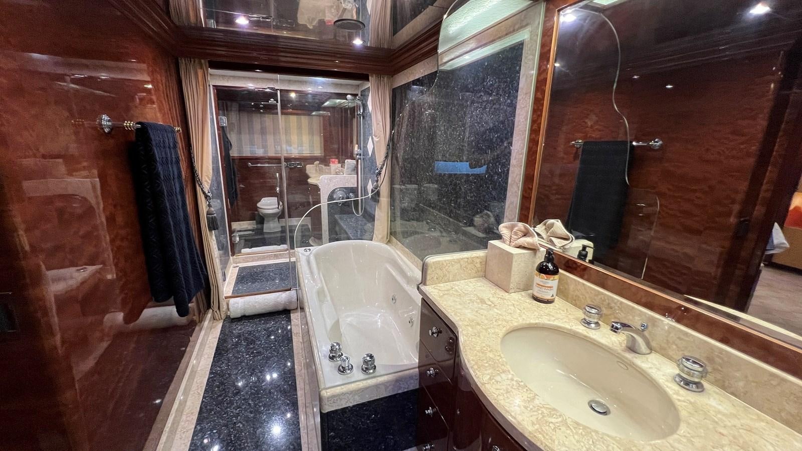 a bathroom with a tub sink and a mirror aboard MISSY B II Yacht for Sale