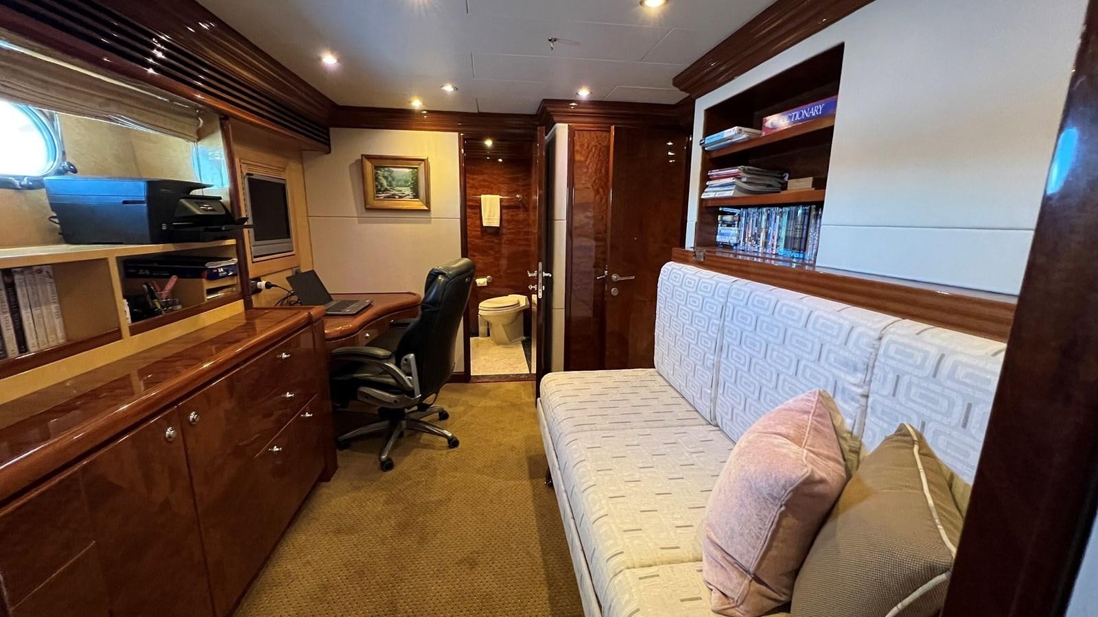 a room with a bed and a desk aboard MISSY B II Yacht for Sale
