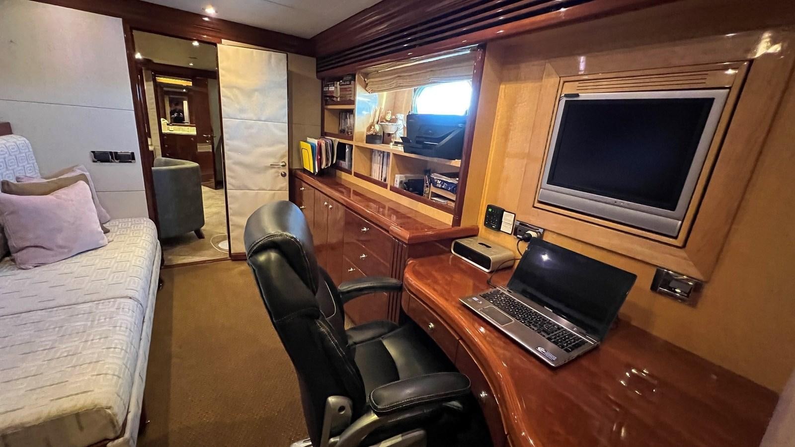 a bedroom with a desk and a bed aboard MISSY B II Yacht for Sale