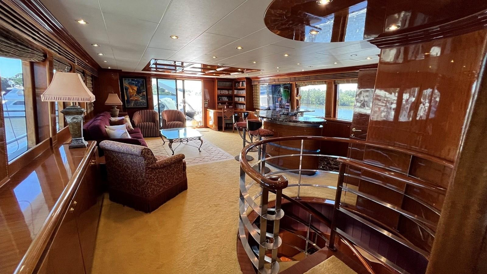 a large living room with wood furniture aboard MISSY B II Yacht for Sale