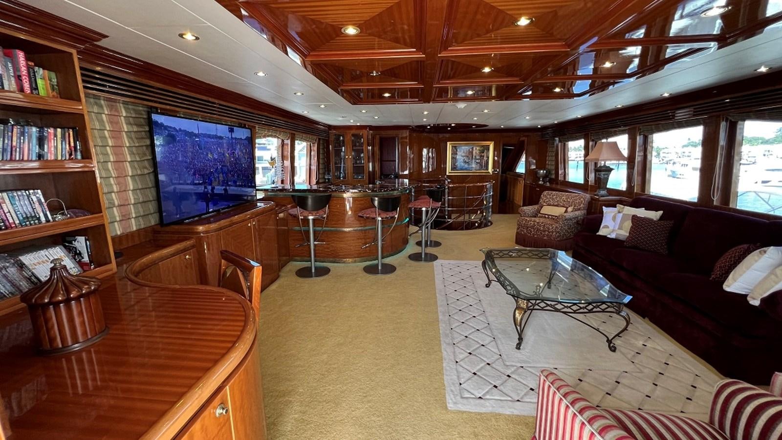 a living room with a large screen aboard MISSY B II Yacht for Sale