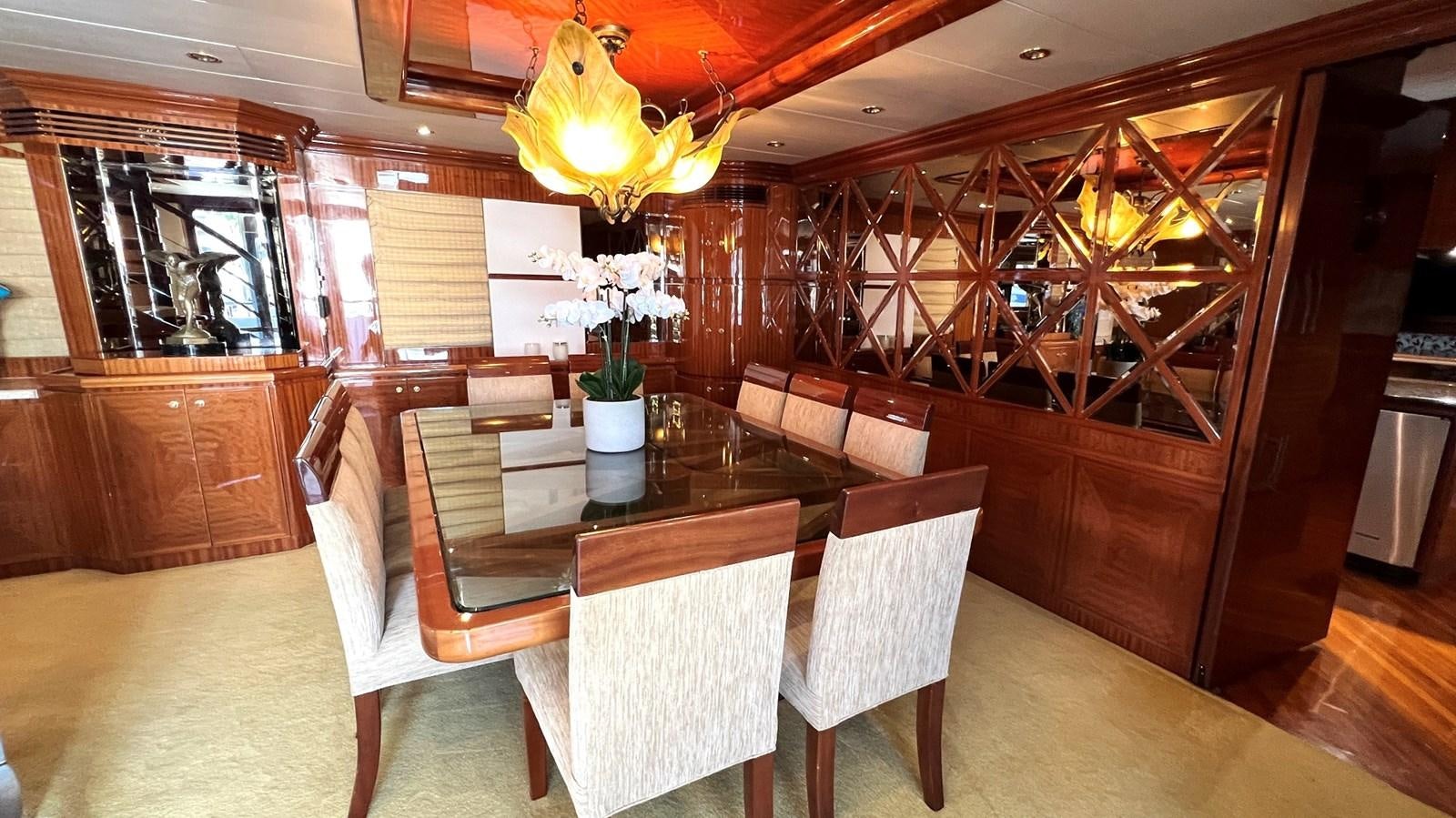 a dining room with a table and chairs aboard MISSY B II Yacht for Sale