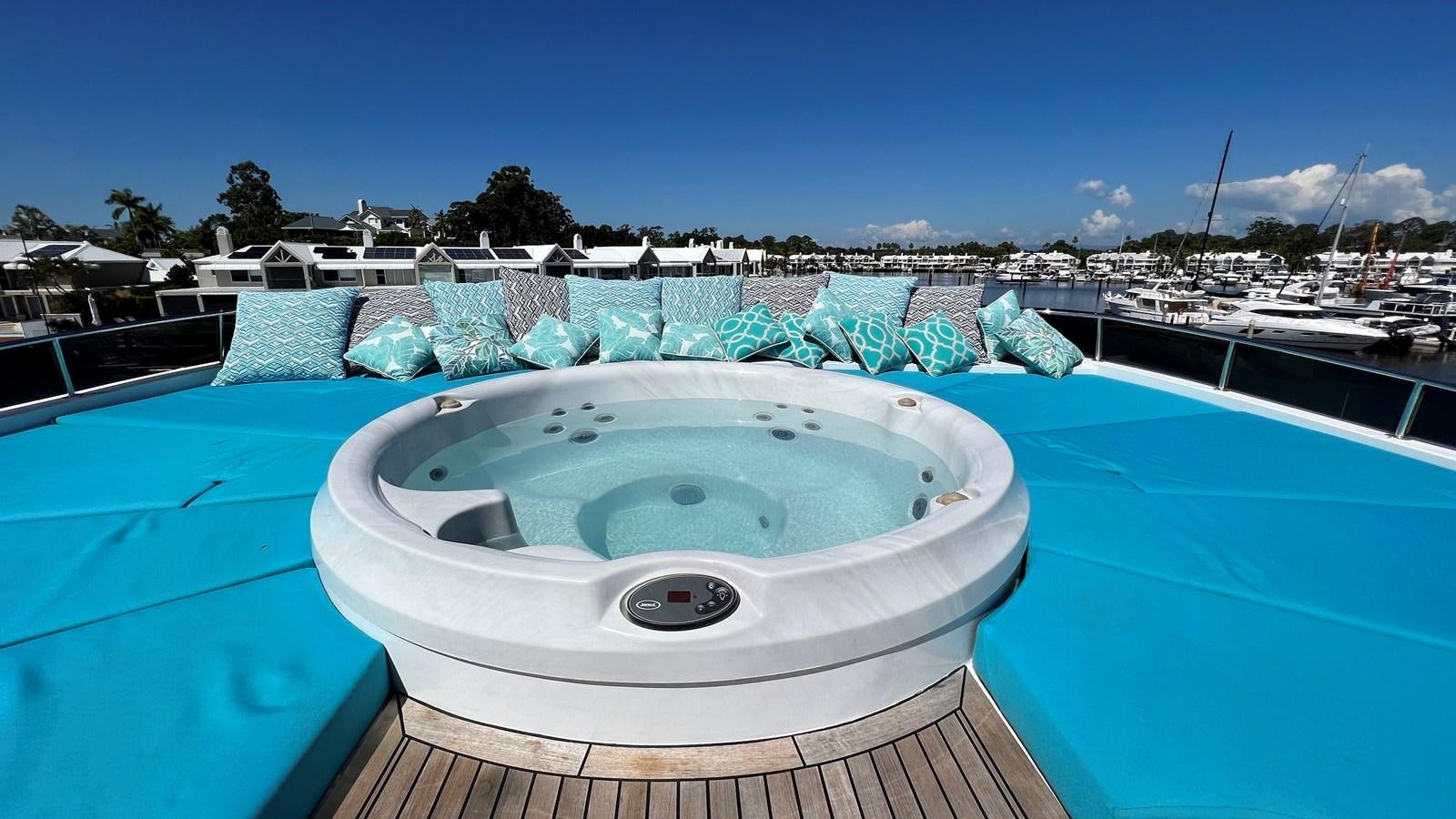 a pool with a round white trampoline and a blue sky aboard MISSY B II Yacht for Sale