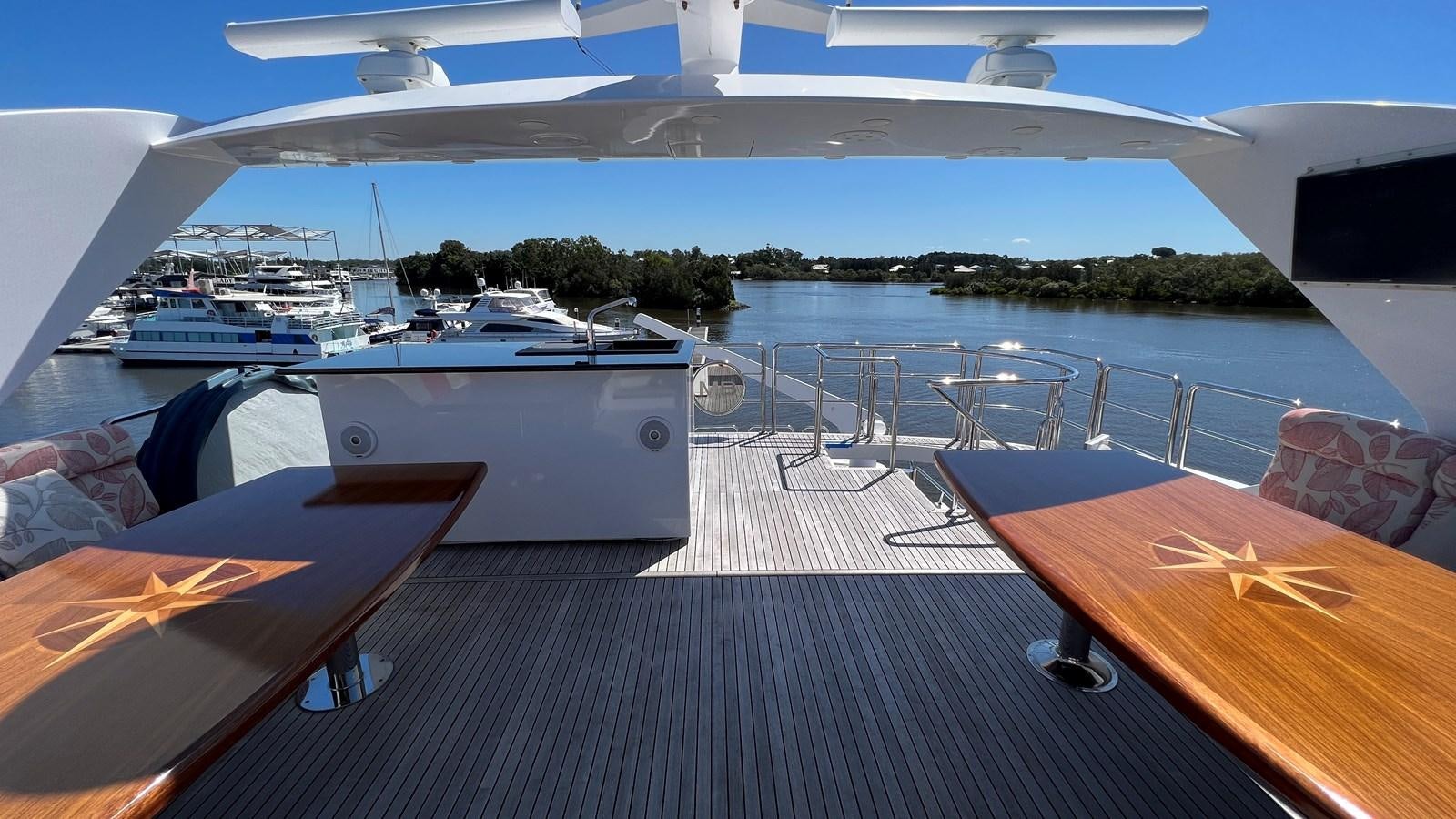 a deck with a view of a marina and boats aboard MISSY B II Yacht for Sale