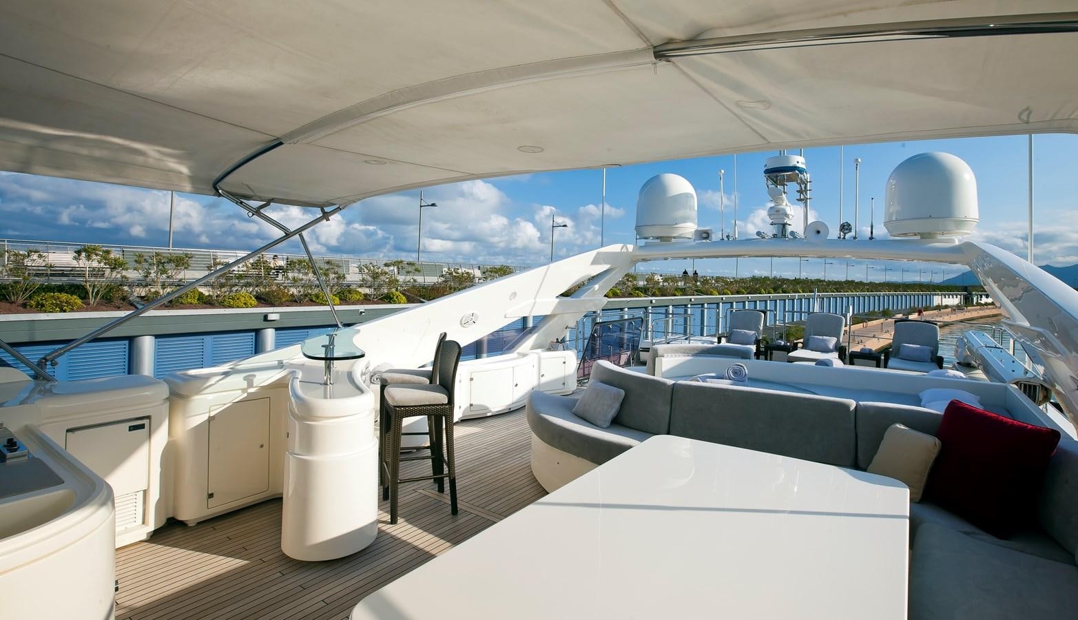 a room with a large white table and chairs and a large white building with a view of the aboard LADY MARIA Yacht for Sale