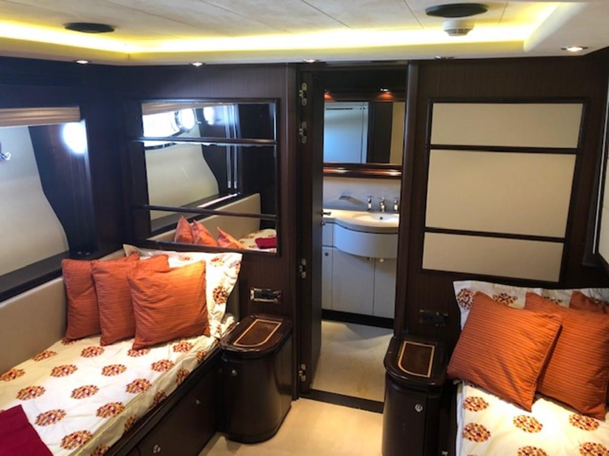 a small bedroom with a large mirror aboard LADY MARIA Yacht for Sale