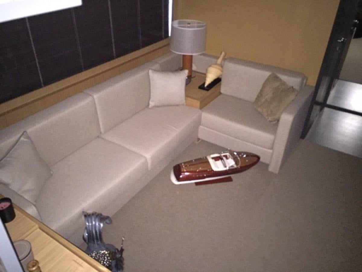 a couch and a coffee table in a room aboard LMPG Yacht for Sale