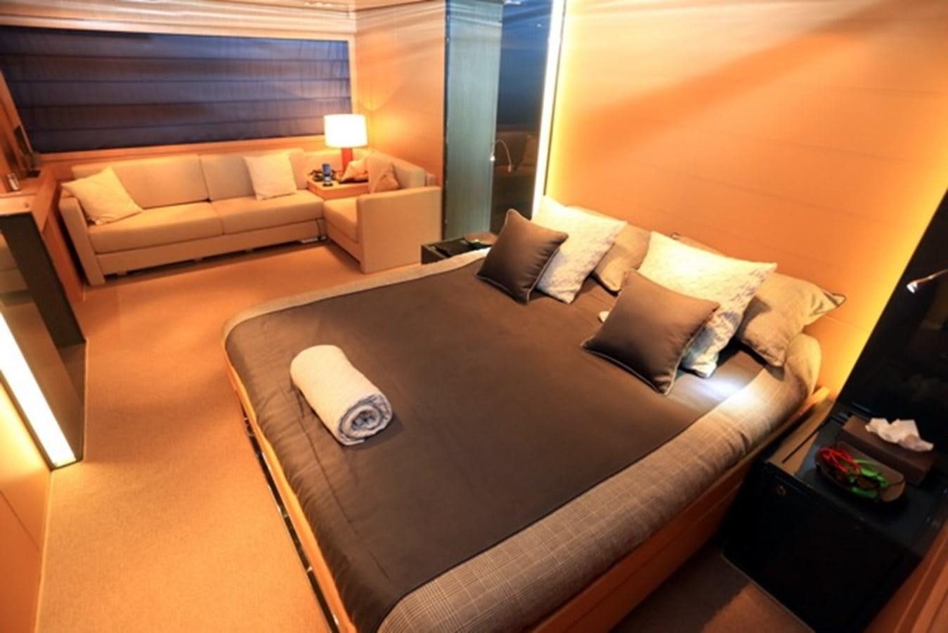 a hotel room with a bed and a couch aboard LMPG Yacht for Sale