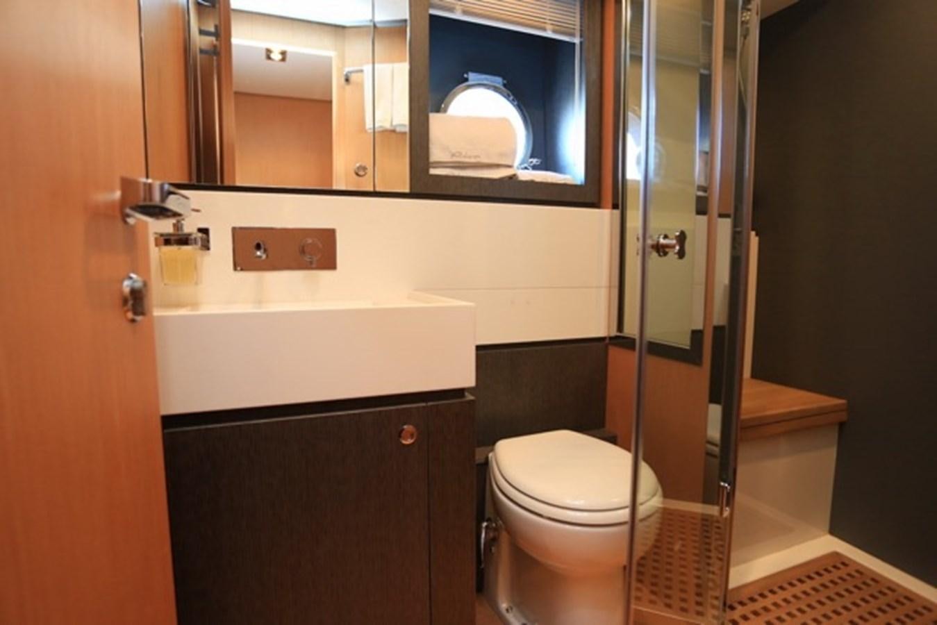 a bathroom with a glass shower aboard LMPG Yacht for Sale