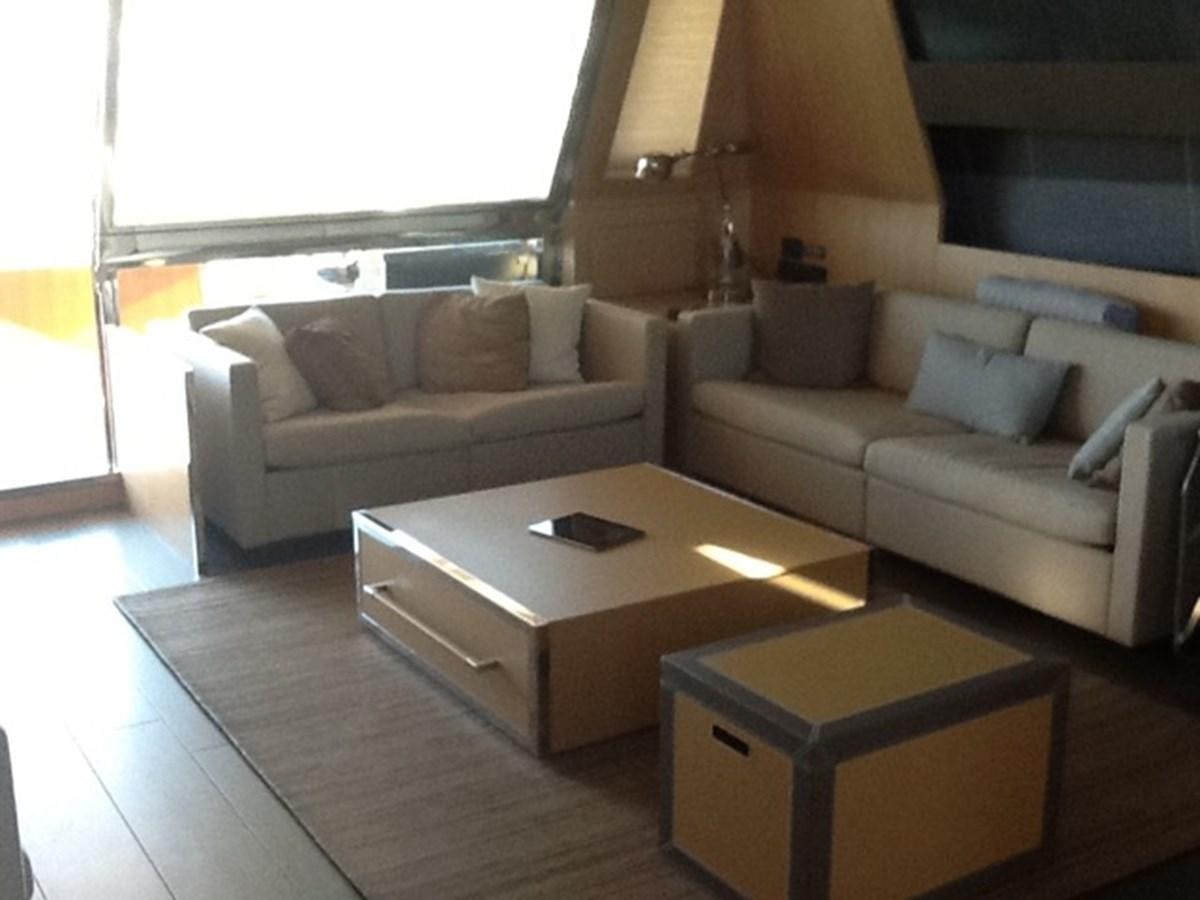 a living room with a couch and a coffee table aboard LMPG Yacht for Sale