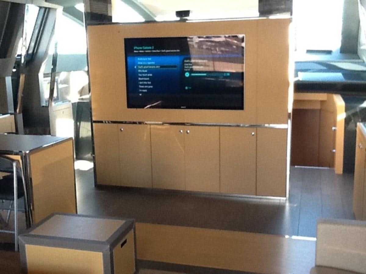 a room with a tv and a table aboard LMPG Yacht for Sale