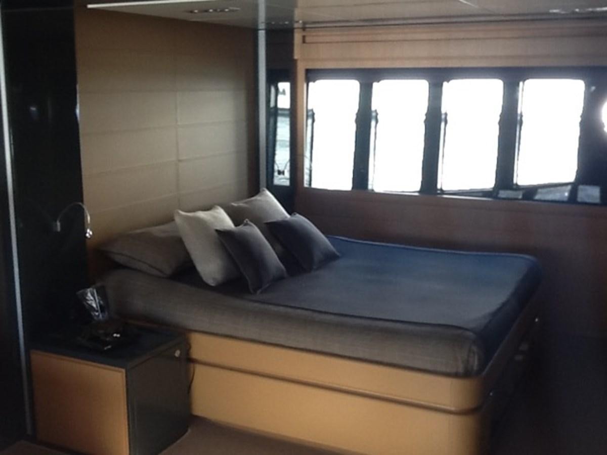 a bed with a blue bed spread aboard LMPG Yacht for Sale