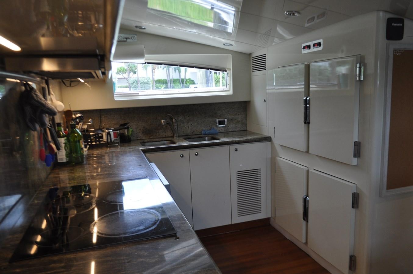 a kitchen with white cabinets aboard TAKA TAKA III Yacht for Sale