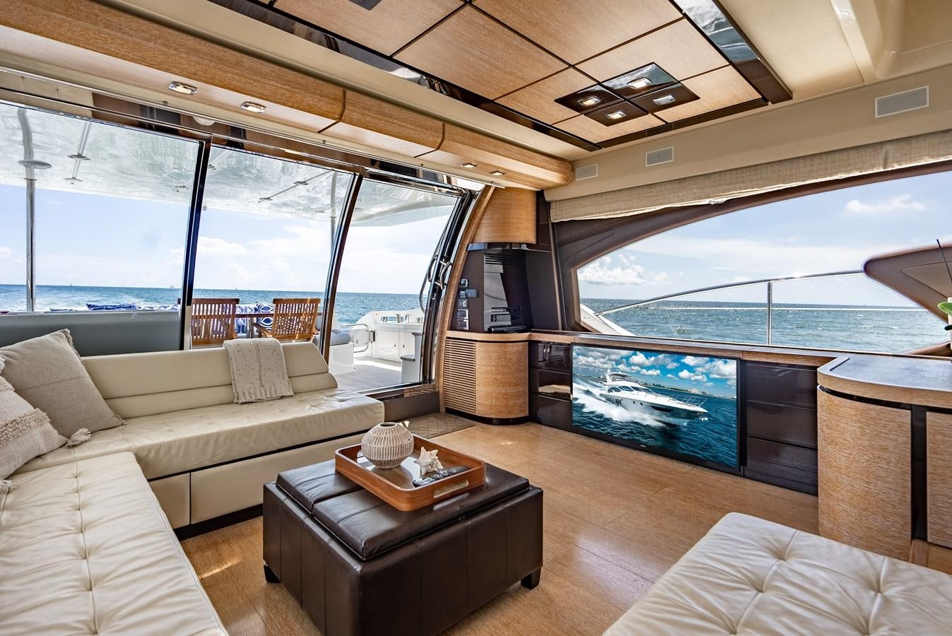 a room with a couch and a table and a tv aboard DAYS LIKE THIS Yacht for Sale