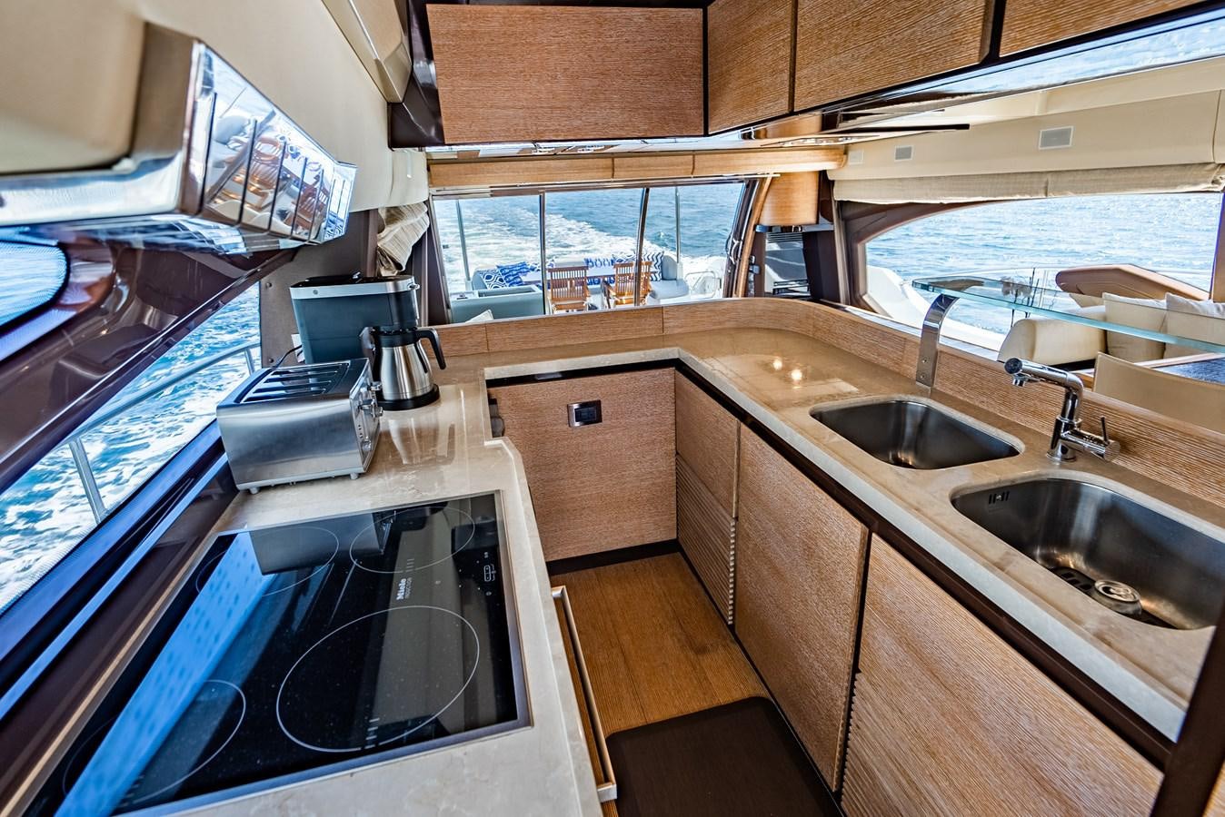 a kitchen with wooden cabinets aboard DAYS LIKE THIS Yacht for Sale