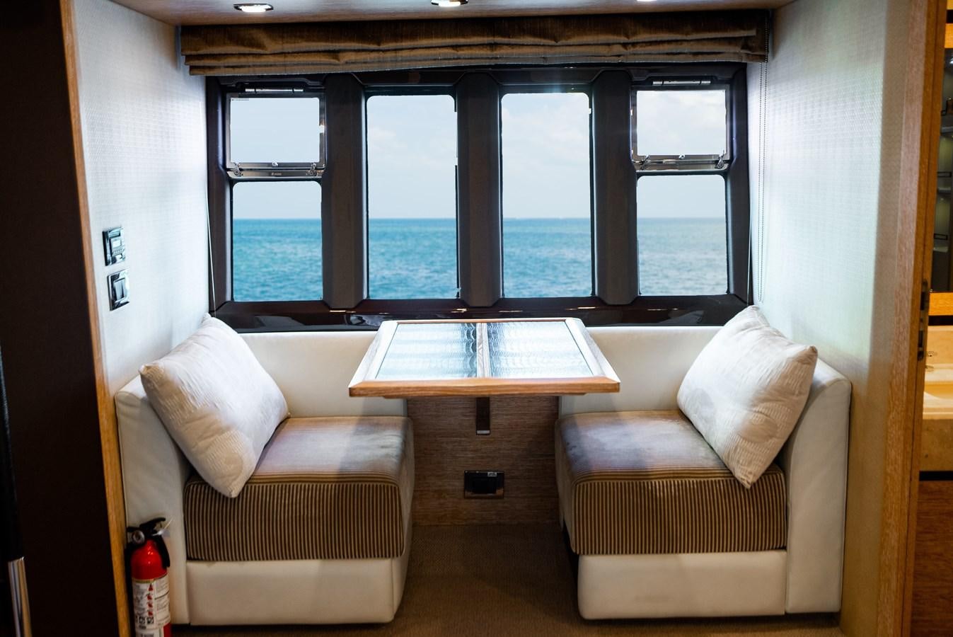 a room with a table and chairs aboard DAYS LIKE THIS Yacht for Sale