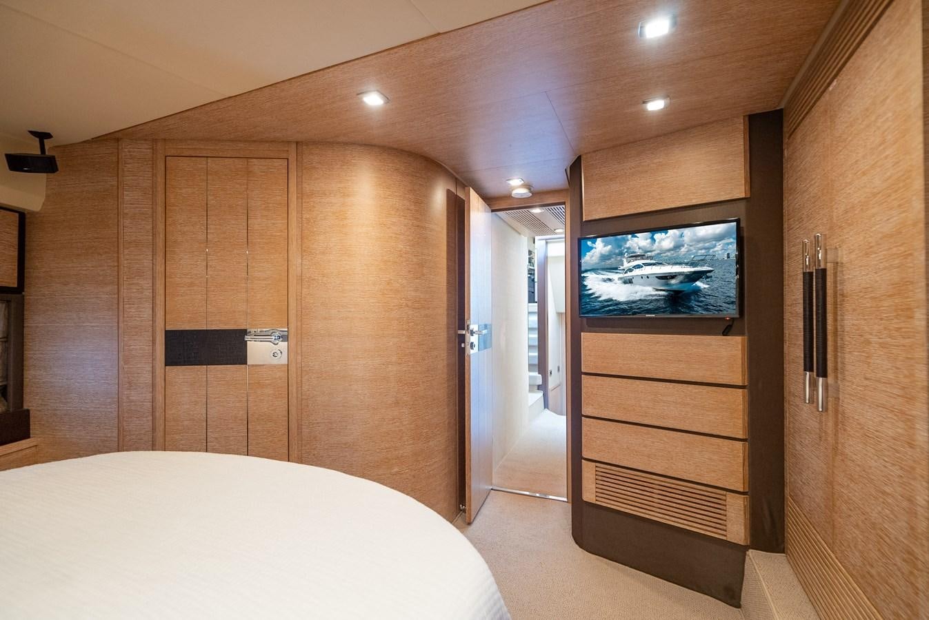a room with a bed and a television aboard DAYS LIKE THIS Yacht for Sale