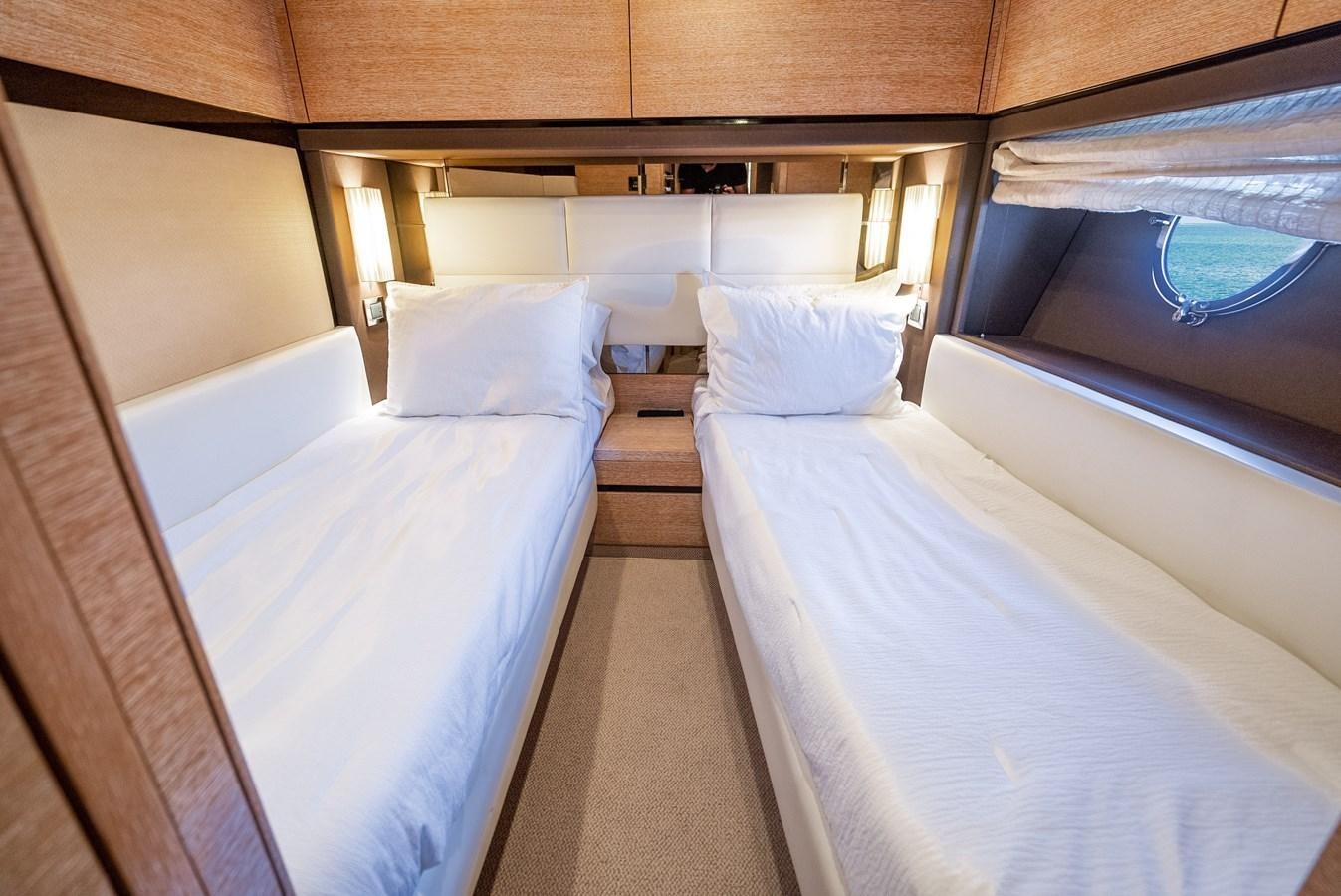 a room with beds and a window aboard DAYS LIKE THIS Yacht for Sale