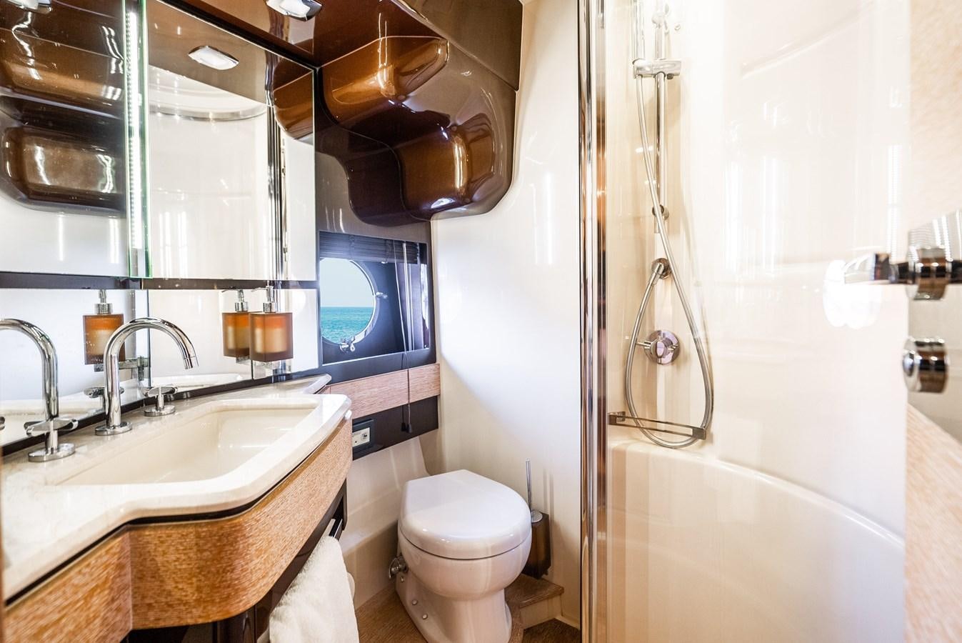 a bathroom with a toilet sink and a mirror aboard DAYS LIKE THIS Yacht for Sale