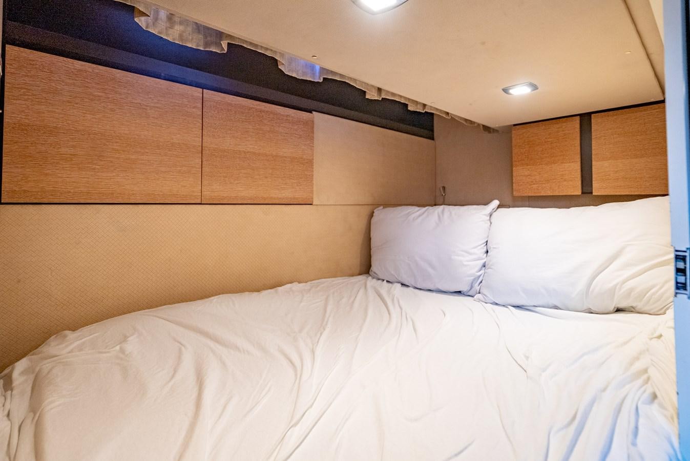 a bed with white sheets aboard DAYS LIKE THIS Yacht for Sale