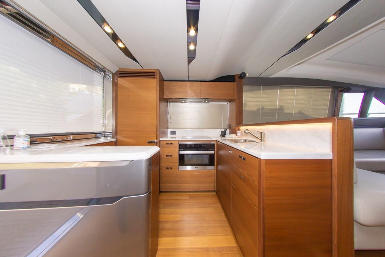a kitchen with wooden cabinets aboard V65 PRINCESS Yacht for Sale