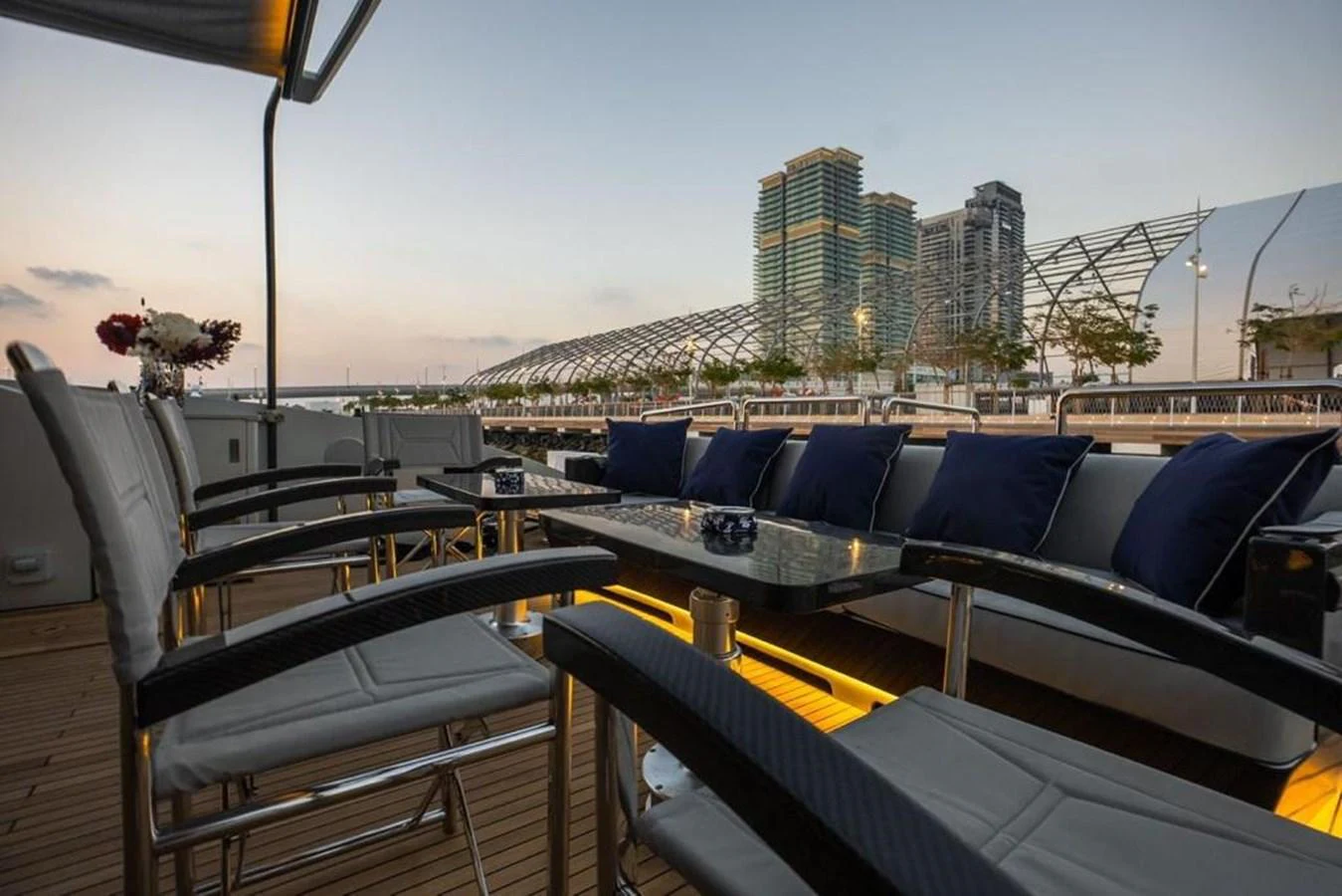 a deck with many seats and tables aboard HIGH ROLLER Yacht for Sale