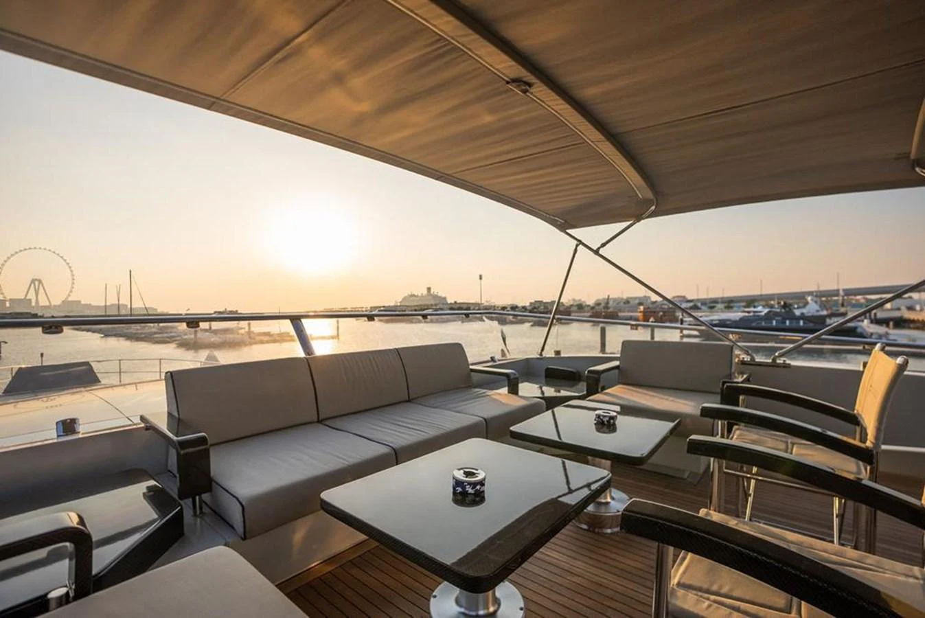 a room with a couch and a table with a view of the water aboard HIGH ROLLER Yacht for Sale