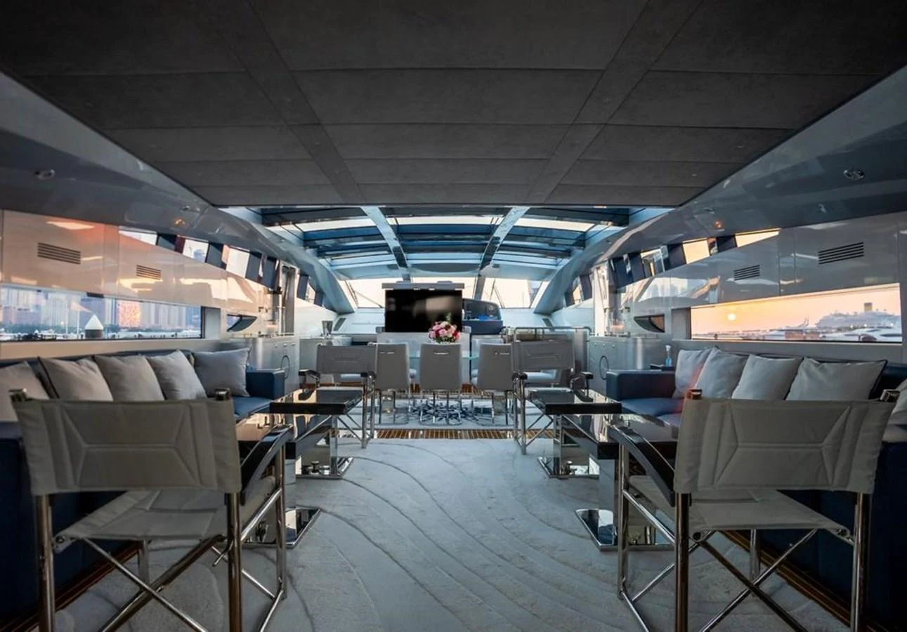 a room with chairs and tables aboard HIGH ROLLER Yacht for Sale