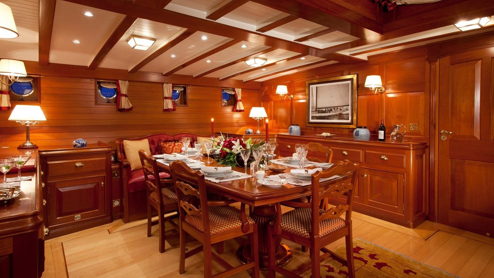 a dining room table and chairs aboard ELENA OF LONDON Yacht for Charter