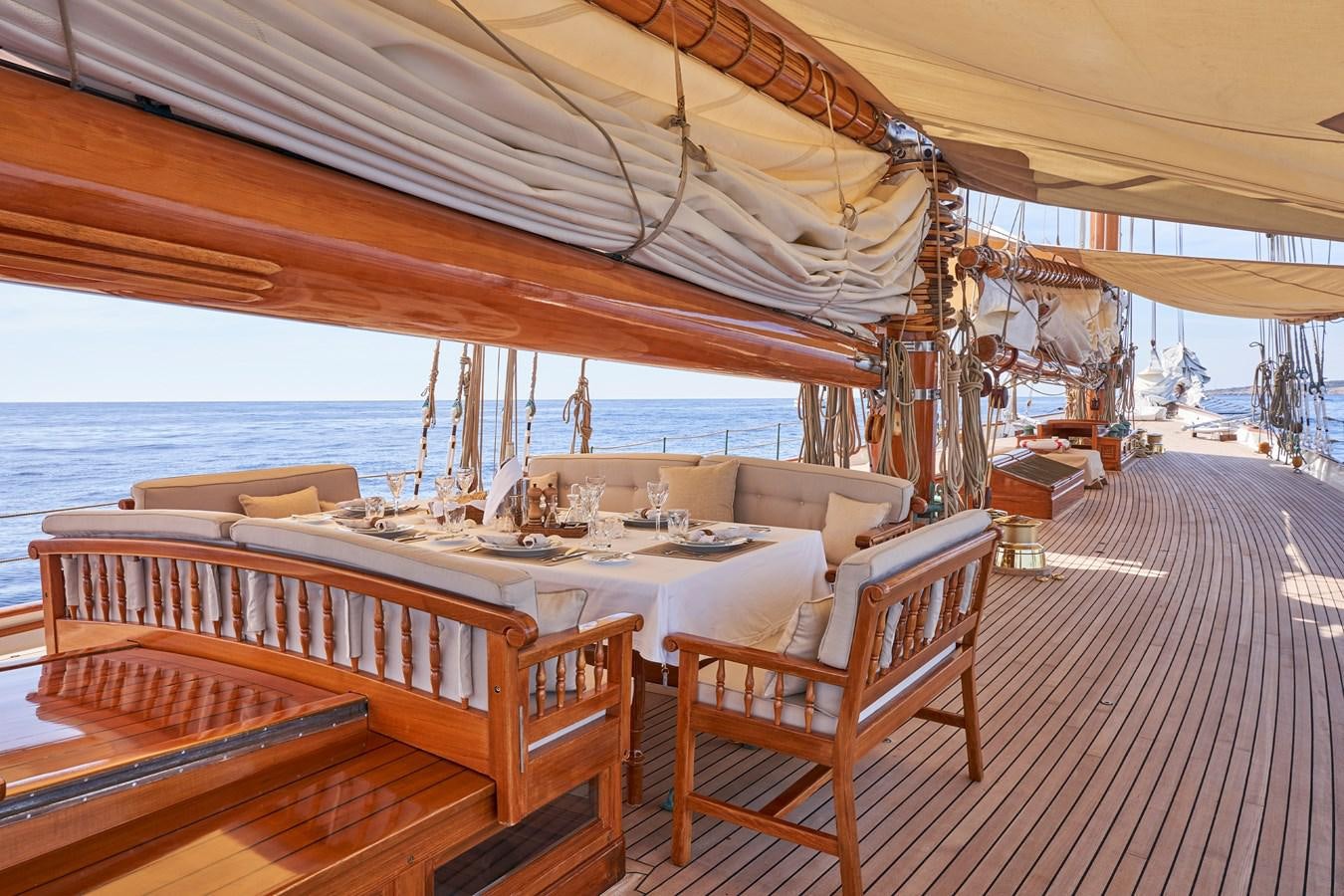 a covered patio with a table and chairs on it aboard ELENA OF LONDON Yacht for Sale