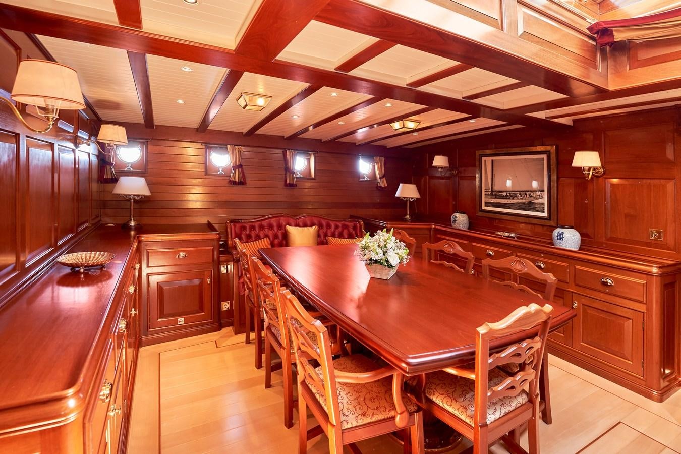 a large dining room with wood paneling aboard ELENA OF LONDON Yacht for Sale