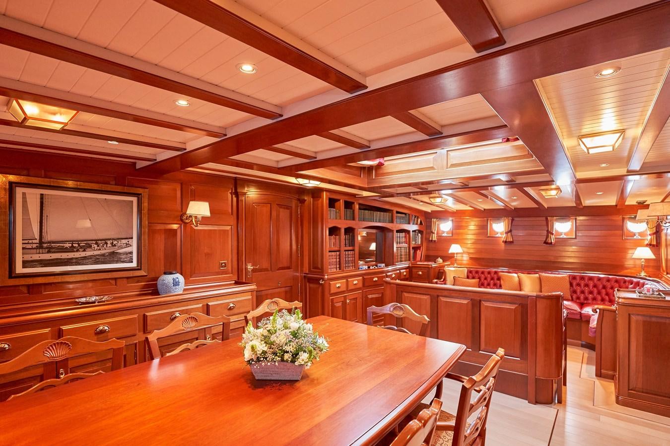 a large room with wooden tables and chairs aboard ELENA OF LONDON Yacht for Sale